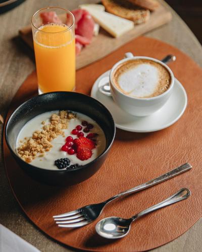 a table with a bowl of cereal and a cup of coffee at Castello di Limatola in Limatola