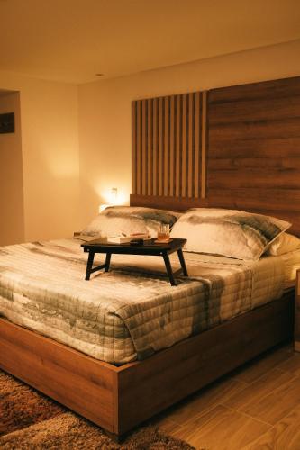 a bedroom with a large bed with a table on it at drb Suites in Cali