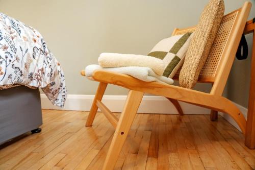 a wooden rocking chair with a blanket on it at Cluain Abhainn 2-4 guests, private entrance in Westport