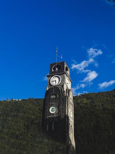 a clock tower on top of a hill at Hotel Agave Baños in Baños