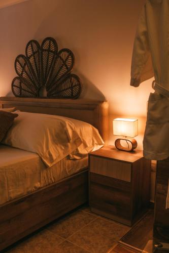 a bedroom with a bed with a lamp on a night stand at drb Suites in Cali