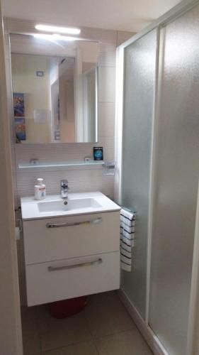 a bathroom with a sink and a mirror at Casa Margot in Sanremo