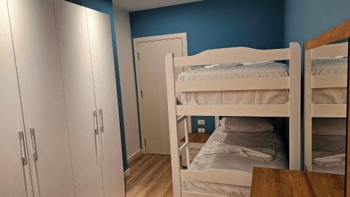 a room with two bunk beds and a table at Tirana Airport Apartment in Tirana