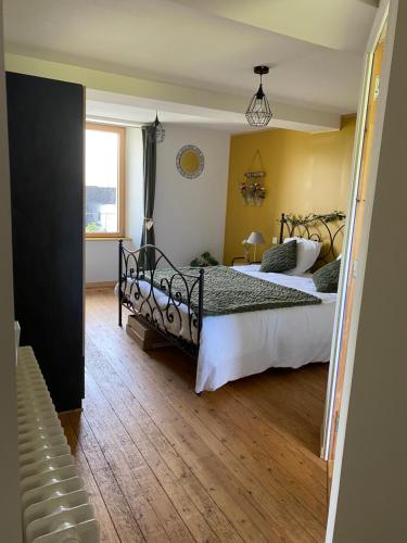 a bedroom with a bed and a window at La pautière in Saint-Sauveur-Lendelin