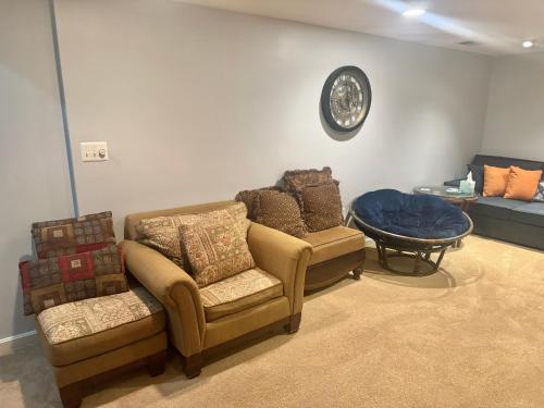 a living room with two chairs and a table at Lakeview - Tranquille private suite in Burke