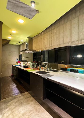 a large kitchen with a large sink and a counter at Turn Back the clock Homestay in Dongshan