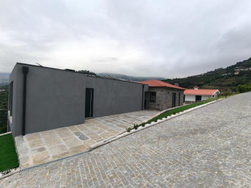 a house on the side of a hill at Quinta do Tojo in Alufinha