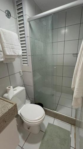 a bathroom with a toilet and a glass shower at Gran Solare Flat Residence - Mandacaru 505 in Barreirinhas