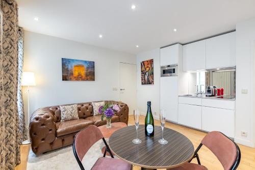 un salon avec une table et un canapé dans l'établissement Appartement Cosy au cœur du Triangle d Or avec Climatisation, à Paris