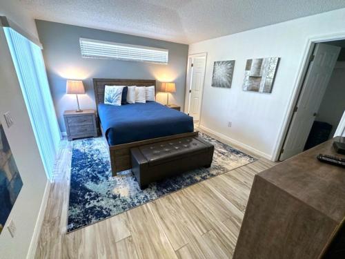 a bedroom with a blue bed and a blue rug at Updated Private Villa Southern Dunes Extended Pool Deck in Haines City