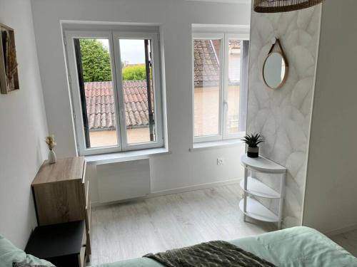 Cette chambre blanche dispose d'un miroir et d'une table. dans l'établissement Maison centre ville Ardres, à Ardres