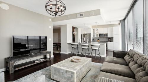 a living room with a couch and a tv at Piedmont Park 3 bdrm with city views in Atlanta