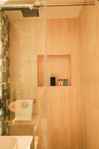 a bathroom with a shower with a toilet and a sink at drb Suites in Cali