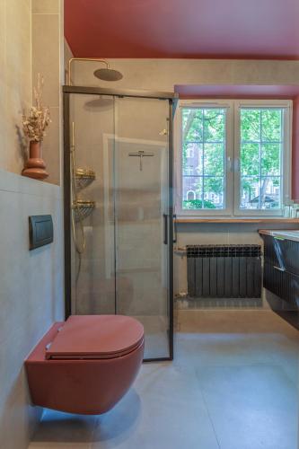 a bathroom with a toilet and a shower at Amber Apartament in Gdańsk