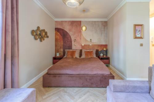 a bedroom with a large bed in a room at Amber Apartament in Gdańsk