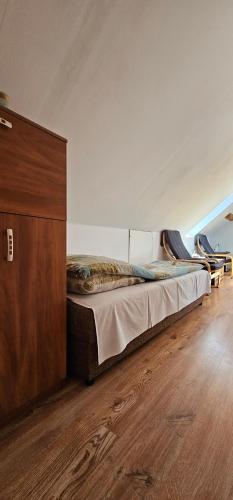 a bedroom with a bed and a wooden cabinet at Keja in Łeba
