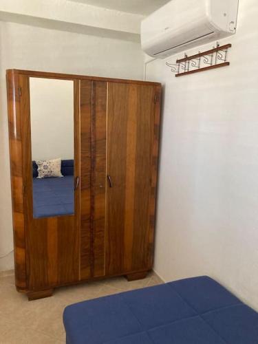 a room with a wooden cabinet in a room at Vila Klara- Blue room in Olib