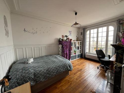 une chambre avec un lit sur lequel est allongé un chat dans l'établissement Paris style park view 5 bedrooms familly subway 6, à Paris