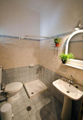 a bathroom with a toilet and a sink at Violetta Apartments in Neo Klima