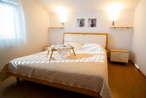 a bedroom with a bed with a table on it at Apartments Anita Frane in Vodice