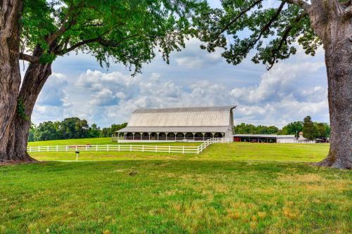 a white barn with a white fence and trees at Bright and Elegant Home in High Point with Deck! in High Point