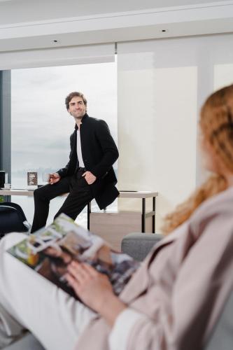 a man in a suit sitting in front of a woman at Pullman Vina del Mar San Martin in Viña del Mar