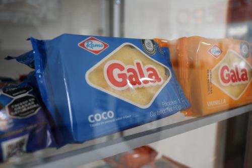 two bags of crisps and chips on a shelf at Hotel Casa Botero 202 in Bogotá