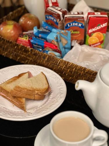 a plate with a piece of bread and a cup of coffee at Status Motel Ourinhos in Ourinhos