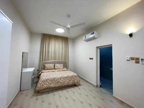 a bedroom with a bed and a ceiling fan at شقق مفروشة صلالة - Furnished Apartments Salalah in Salalah