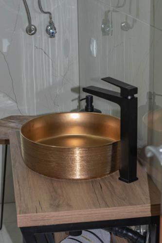a copper sink on a wooden counter in a bathroom at Apartments Anita Frane in Vodice