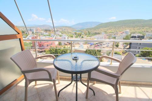 a table and chairs on a balcony with a view at Hotel Milo Ksamil in Ksamil