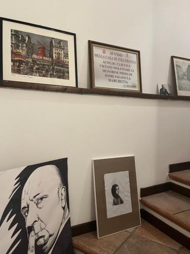 a shelf with pictures of a man on it at Sinilù B&B in Silvi Paese