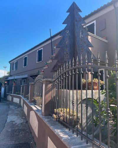 a fence in front of a building with a christmas tree at Sinilù B&B in Silvi Paese