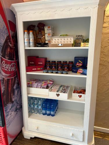 a refrigerator filled with lots of food and drinks at Larocca Tourist Home 3 Valbrenta in Carpane