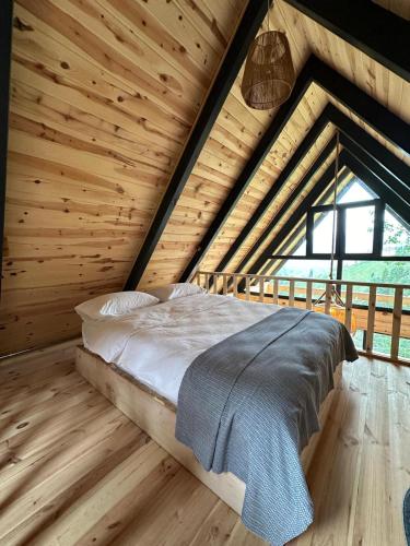 a bedroom with a bed in a wooden room at Dağhan Bungalov in Çamlıhemşin