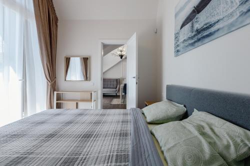 a bedroom with a bed and a couch at Hill Garden Terrace in Palanga