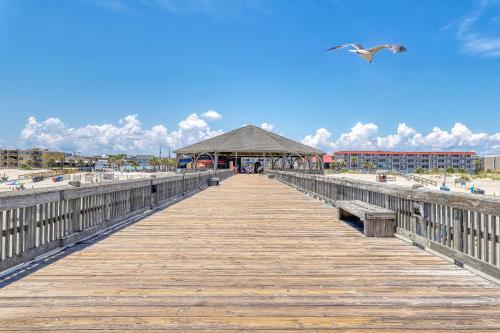 a wooden pier with a gazebo on the beach at Lucky Number #13 in Tybee Island
