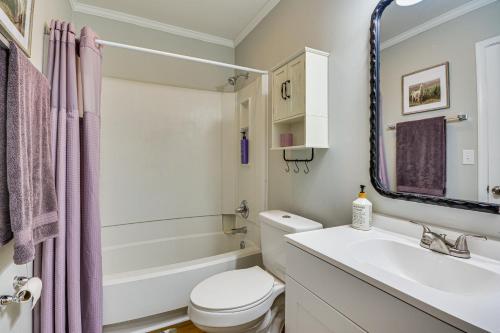 a bathroom with a sink and a toilet and a tub at High Point Townhome with Patio, 1 Mi to Main Street! in High Point