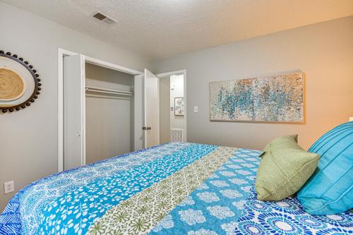 a bedroom with a bed with a blue comforter at High Point Townhome with Patio, 1 Mi to Main Street! in High Point