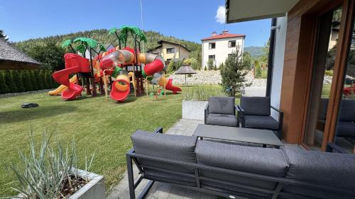 a backyard with a playground with a play equipment at Villa Monica Apartamenty in Szczyrk