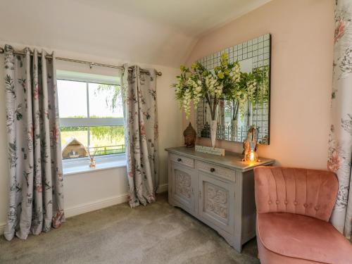 a home office with a chair and a window at The Granary in Boston