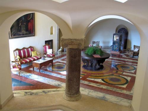 a living room with a couch and a table at Grand Hotel Dei Castelli in Sestri Levante