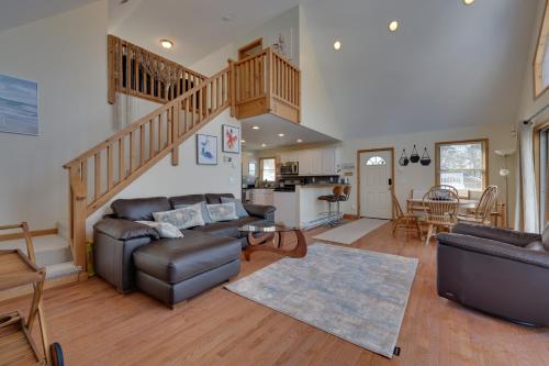 a living room with a couch and a staircase at Large Deck and Resort Amenities Lake Ariel Retreat in Lake Ariel