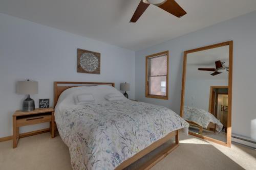 a bedroom with a large bed and a mirror at Large Deck and Resort Amenities Lake Ariel Retreat in Lake Ariel