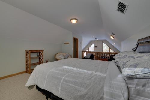 a bedroom with a bed with a white comforter at Large Deck and Resort Amenities Lake Ariel Retreat in Lake Ariel