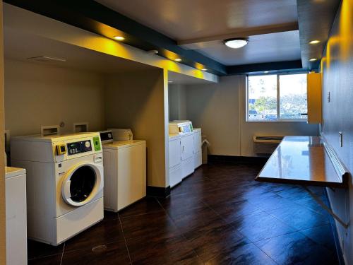a laundry room with a washer and dryer at Studio 6 Suites Carson, CA in Carson