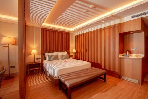 a bedroom with a bed and a bench in it at Casa Lumar Luxury Lodging- Adult Only in Fethiye