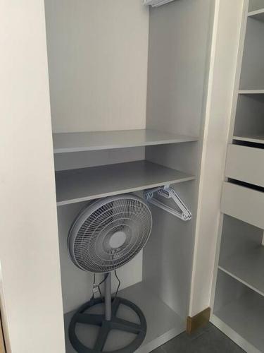 a fan is sitting in a corner of a closet at DN3A Spacious apartment in Cayalá with pool in Guatemala