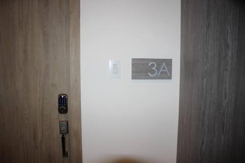 a door with a sign on the side of it at DN3A Spacious apartment in Cayalá with pool in Guatemala