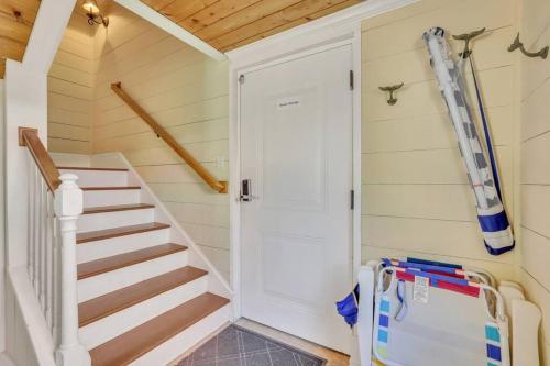 a staircase in a tiny house with a white door at Blue Pearl Beach House Steps from Beach Access in Tybee Island